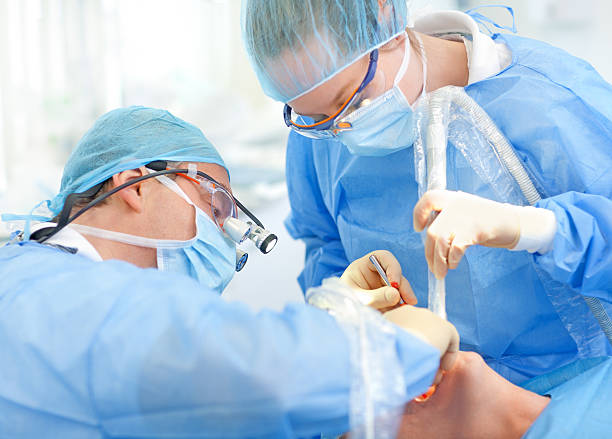 a dentist and assistant performing dental procedure