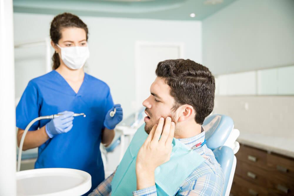 a man with a toothache in the dentist office