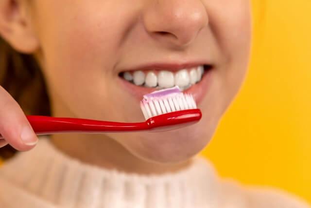 close-up shot of a girl brushing her teeth