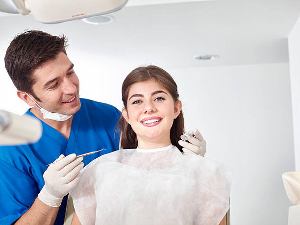 photo of a dentist and his patient smiling after a dental treatment